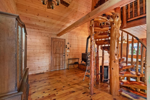 447 Flint Ln, Washburn, MO 65772 - foyer with wood ceiling with exposed beams, wood-type flooring, wooden walls, and a wood stove