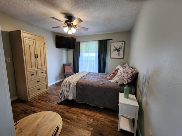 388 Notch Ln Unit 12, Branson West, MO 65737 - bedroom with dark wood-type flooring, a textured ceiling, a ceiling fan, and baseboards