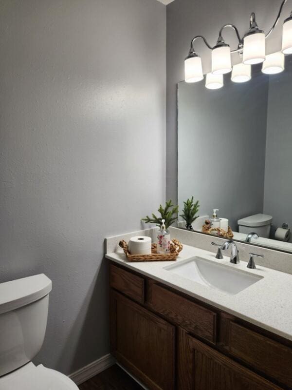388 Notch Ln Unit 12, Branson West, MO 65737 - half bath featuring toilet, vanity, baseboards, and wood finished floors