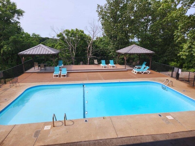 388 Notch Ln Unit 12, Branson West, MO 65737 - view of swimming pool with a gazebo, a deck, and view of wooded area