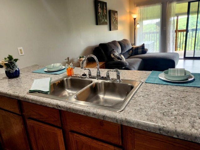 388 Notch Ln Unit 12, Branson West, MO 65737 - kitchen with a sink, light countertops, brown cabinetry, and open floor plan