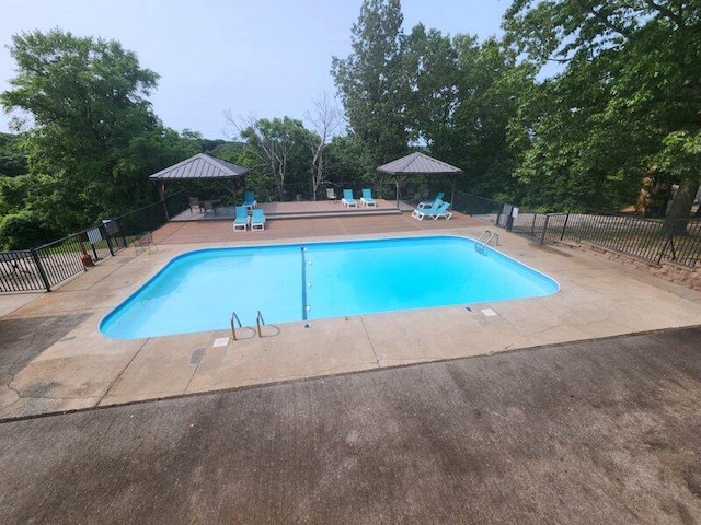 388 Notch Ln Unit 12, Branson West, MO 65737 - community pool featuring a patio area and view of scattered trees