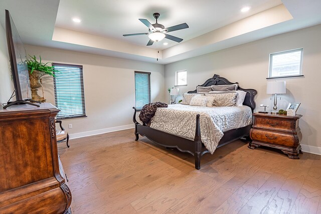 2370 E Cardinal St, Springfield, MO 65804 - bedroom featuring a raised ceiling, wood finished floors, baseboards, multiple windows, and recessed lighting