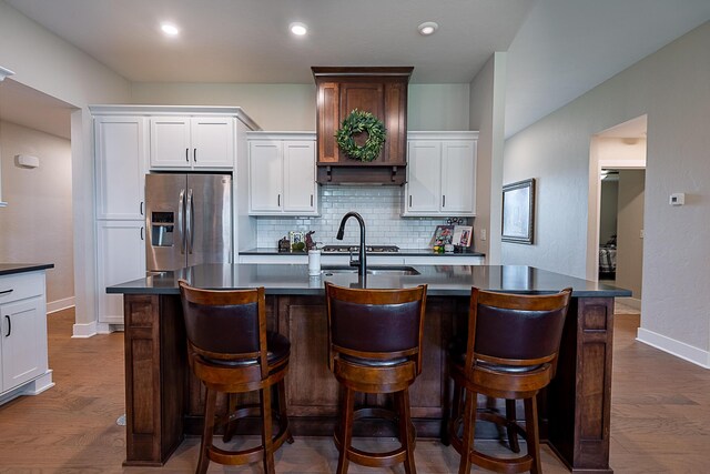 2370 E Cardinal St, Springfield, MO 65804 - kitchen with stainless steel fridge with ice dispenser, dark countertops, backsplash, baseboards, and recessed lighting
