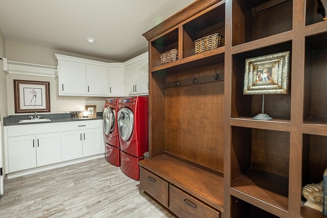 2370 E Cardinal St, Springfield, MO 65804 - laundry room featuring cabinet space, washer and clothes dryer, and light wood finished floors