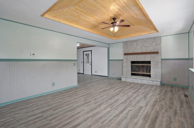 1132 Irene Ct, Nixa, MO 65714 - unfurnished living room featuring a tray ceiling, wood finished floors, ceiling fan, a wainscoted wall, and wood ceiling
