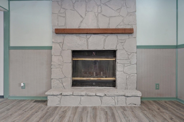 1132 Irene Ct, Nixa, MO 65714 - detailed view of a fireplace, wood finished floors, wainscoting, and baseboards