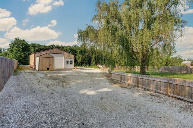 1132 Irene Ct, Nixa, MO 65714 - detached garage with driveway and a shed