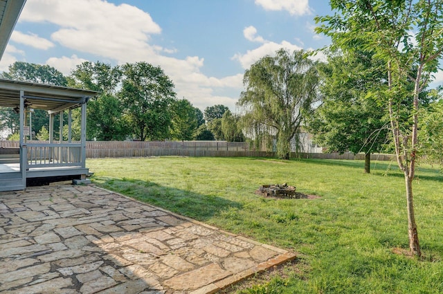 1132 Irene Ct, Nixa, MO 65714 - view of yard featuring a patio, a wooden deck, and an outdoor fire pit