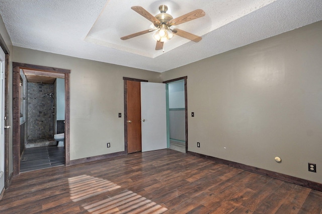 1132 Irene Ct, Nixa, MO 65714 - unfurnished bedroom with dark wood finished floors, baseboards, connected bathroom, and a textured ceiling