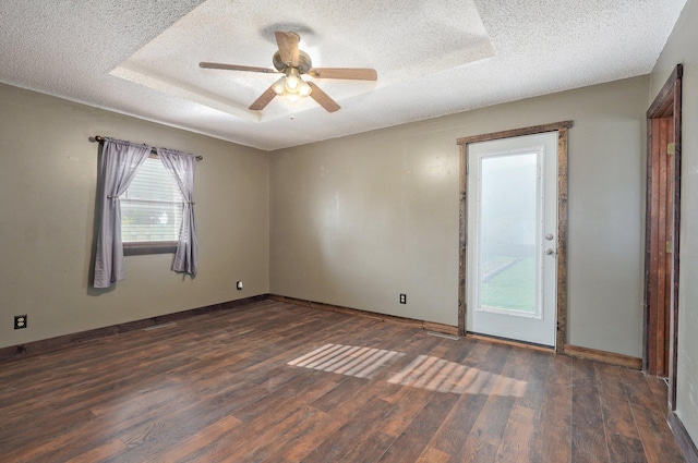1132 Irene Ct, Nixa, MO 65714 - unfurnished room featuring a textured ceiling, wood finished floors, baseboards, ceiling fan, and a tray ceiling