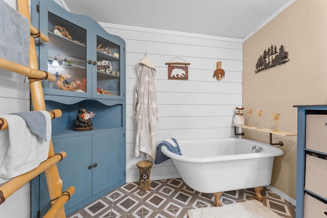 28286 Clay Rd, Eagle Rock, MO 65641 - bathroom with a freestanding bath, a textured ceiling, and crown molding