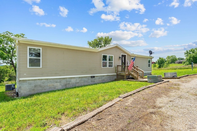 28286 Clay Rd, Eagle Rock, MO 65641 - view of front of home with crawl space, central AC unit, and a front lawn