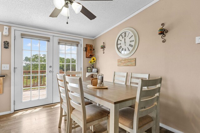 28286 Clay Rd, Eagle Rock, MO 65641 - dining area with a textured ceiling, a ceiling fan, wood finished floors, baseboards, and ornamental molding