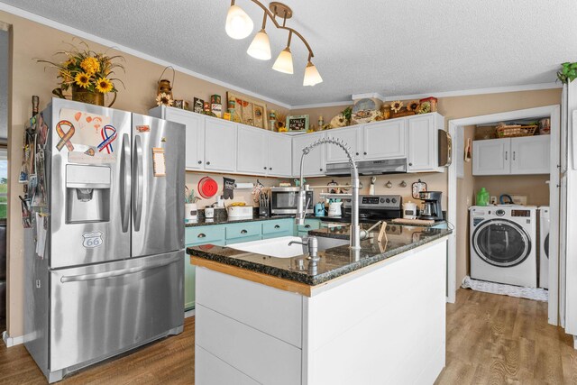 28286 Clay Rd, Eagle Rock, MO 65641 - kitchen featuring appliances with stainless steel finishes, separate washer and dryer, a textured ceiling, under cabinet range hood, and wood finished floors