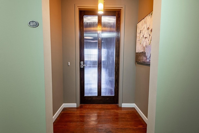 entryway featuring dark wood-style flooring and baseboards