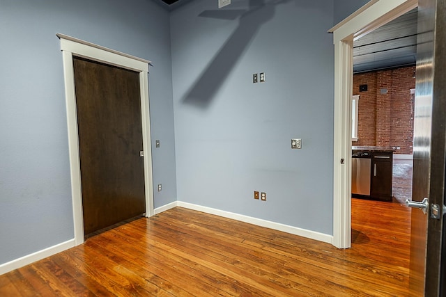 unfurnished room featuring baseboards and wood finished floors