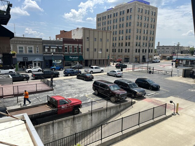 view of property with uncovered parking and central air condition unit