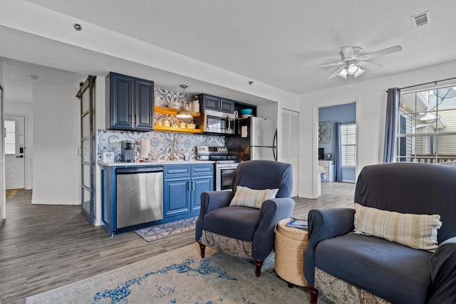 690 Fall Creek Dr Unit 5, Branson, MO 65616 - living area featuring wood finished floors, ceiling fan, and baseboards