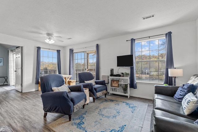 690 Fall Creek Dr Unit 5, Branson, MO 65616 - living room featuring wood finished floors, a textured ceiling, baseboards, and ceiling fan