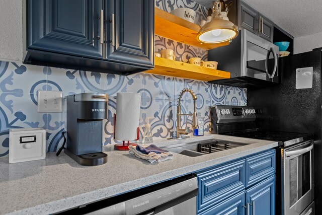 690 Fall Creek Dr Unit 5, Branson, MO 65616 - kitchen with appliances with stainless steel finishes, blue cabinetry, decorative backsplash, light countertops, and open shelves