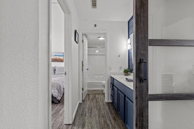 690 Fall Creek Dr Unit 5, Branson, MO 65616 - ensuite bathroom with toilet, wood finished floors, vanity, a shower, and a textured wall