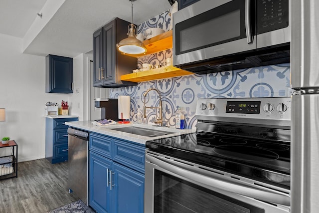 690 Fall Creek Dr Unit 5, Branson, MO 65616 - kitchen featuring appliances with stainless steel finishes, blue cabinetry, a sink, light countertops, and dark wood finished floors