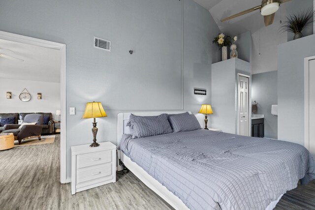 690 Fall Creek Dr Unit 5, Branson, MO 65616 - bedroom with high vaulted ceiling, wood finished floors, and connected bathroom