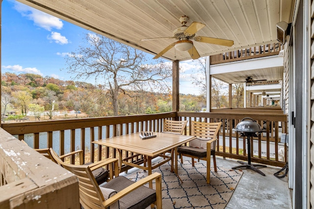690 Fall Creek Dr Unit 5, Branson, MO 65616 - wooden terrace with ceiling fan, outdoor dining area, and a water view