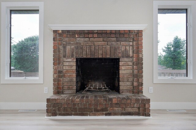 1436 W Whiteside St, Springfield, MO 65807 - detailed view of wood finished floors, a fireplace, and baseboards
