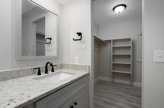 1436 W Whiteside St, Springfield, MO 65807 - bathroom with vanity, wood finished floors, and baseboards
