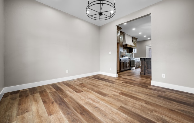 1691 S Charles Pl, Bolivar, MO 65613 - unfurnished dining area featuring a chandelier, wood finished floors, baseboards, and recessed lighting