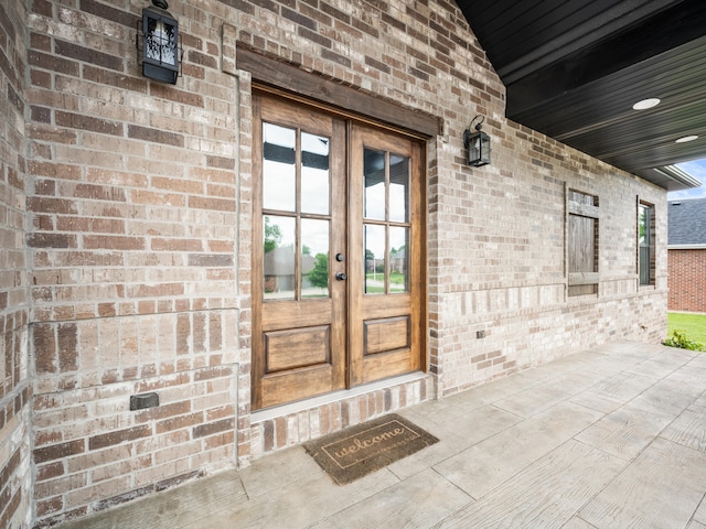 1691 S Charles Pl, Bolivar, MO 65613 - view of exterior entry featuring french doors and brick siding