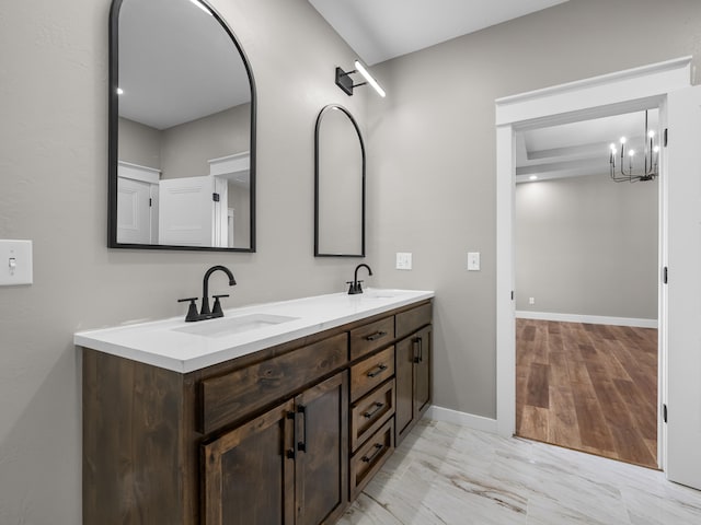 1691 S Charles Pl, Bolivar, MO 65613 - bathroom with double vanity, baseboards, and a chandelier