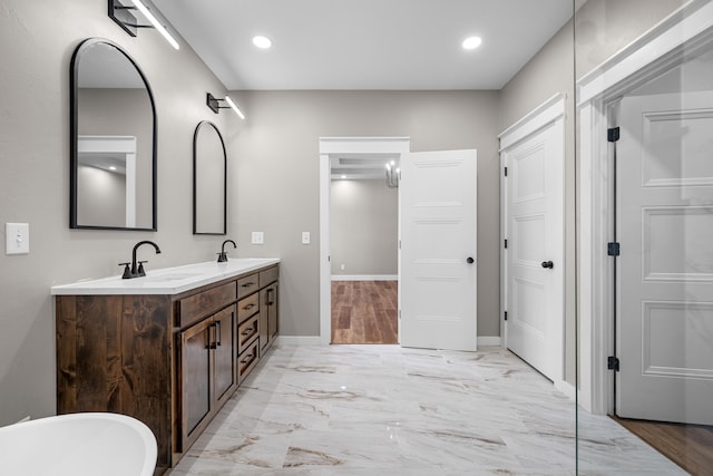 1691 S Charles Pl, Bolivar, MO 65613 - bathroom with double vanity, a soaking tub, baseboards, recessed lighting, and marble finish floors