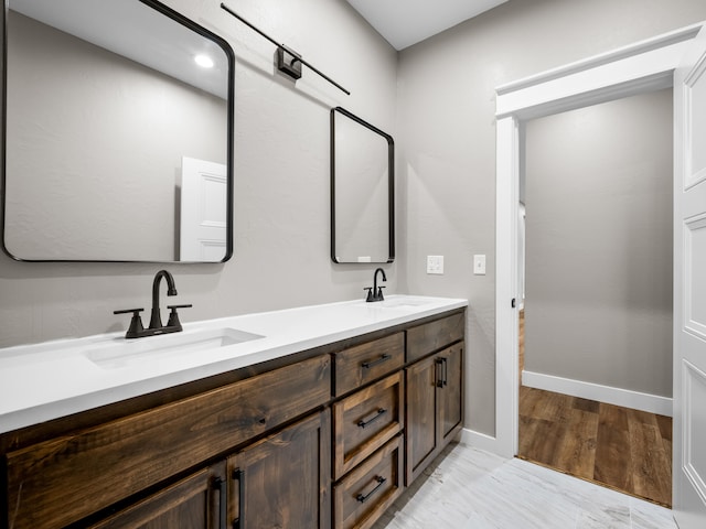 1691 S Charles Pl, Bolivar, MO 65613 - bathroom featuring double vanity and baseboards
