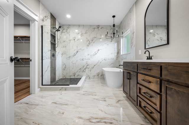 1691 S Charles Pl, Bolivar, MO 65613 - bathroom with a marble finish shower, vanity, a freestanding tub, a walk in closet, and marble finish flooring