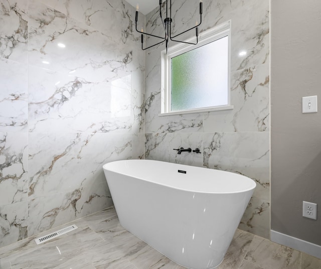 1691 S Charles Pl, Bolivar, MO 65613 - full bathroom featuring marble tiled floors, a freestanding tub, and a chandelier