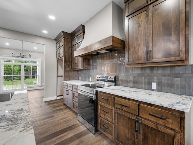 1691 S Charles Pl, Bolivar, MO 65613 - kitchen with stainless steel range with electric stovetop, custom exhaust hood, wood finished floors, decorative backsplash, and recessed lighting