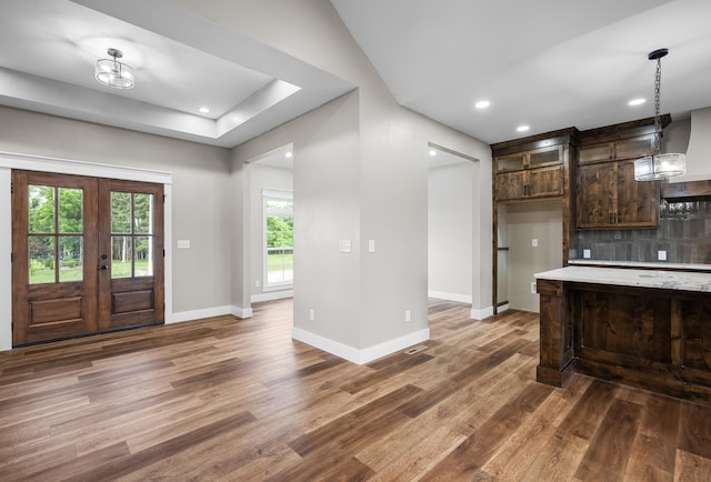 1691 S Charles Pl, Bolivar, MO 65613 - kitchen featuring wood finished floors, light countertops, dark brown cabinets, tasteful backsplash, and french doors