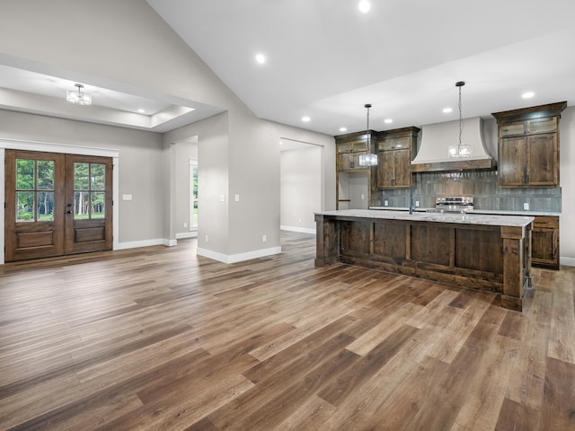 1691 S Charles Pl, Bolivar, MO 65613 - kitchen featuring custom range hood, recessed lighting, light countertops, wood finished floors, and tasteful backsplash