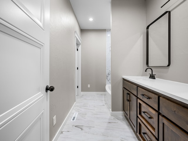1691 S Charles Pl, Bolivar, MO 65613 - bathroom with a bath, vanity, baseboards, marble finish floors, and recessed lighting