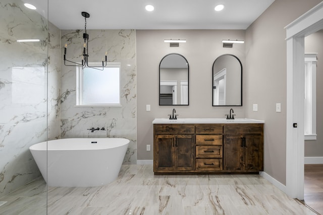 1691 S Charles Pl, Bolivar, MO 65613 - full bath with marble finish flooring, a freestanding tub, double vanity, recessed lighting, and a chandelier