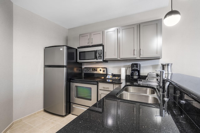 2204A Branson Landing Blvd, Branson, MO 65616 - kitchen with appliances with stainless steel finishes, a sink, gray cabinets, pendant lighting, and dark stone countertops
