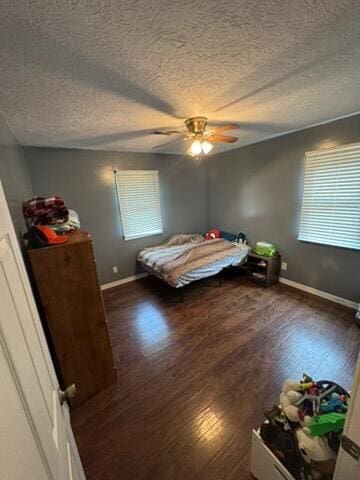 9153 N Hwy Highway, Mountain Grove, MO 65711 - bedroom with a textured ceiling, wood finished floors, baseboards, and a ceiling fan