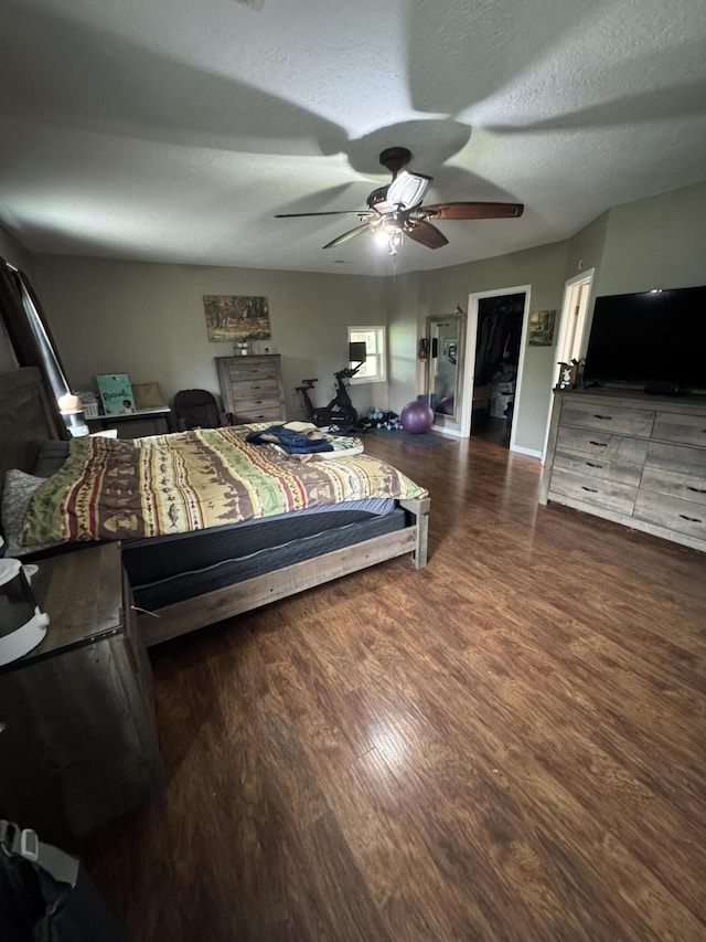 9153 N Hwy Highway, Mountain Grove, MO 65711 - bedroom featuring wood finished floors, a textured ceiling, ceiling fan, and baseboards