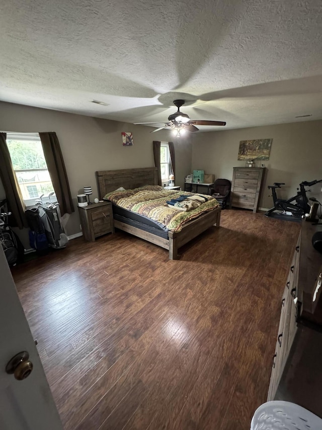 9153 N Hwy Highway, Mountain Grove, MO 65711 - bedroom with multiple windows, wood finished floors, a textured ceiling, and a ceiling fan