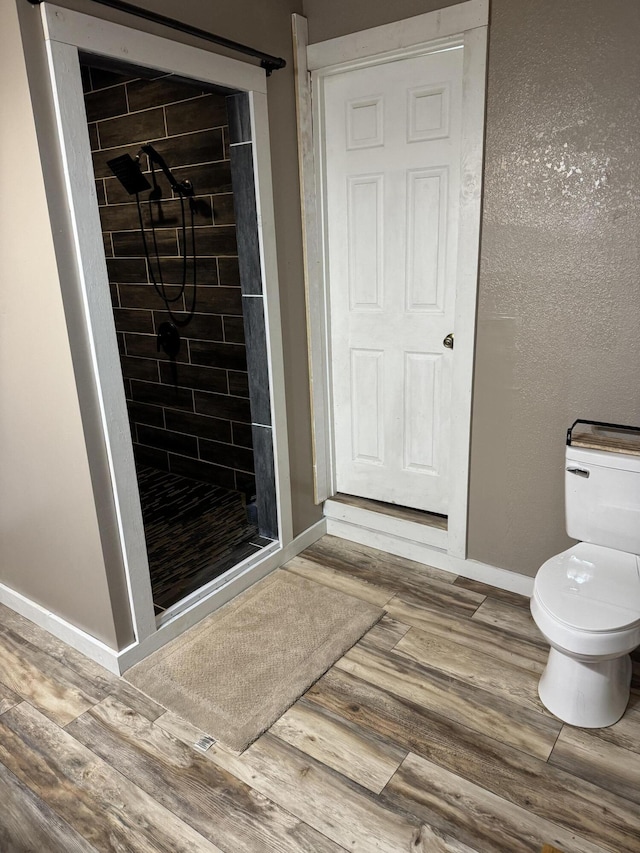 9153 N Hwy Highway, Mountain Grove, MO 65711 - bathroom with a shower stall, baseboards, toilet, and wood finished floors