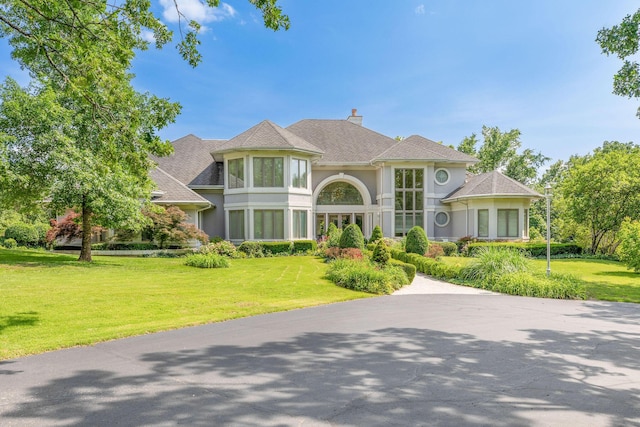 193 Honeybee Dr, Branson, MO 65615 - view of front of property featuring stucco siding, a chimney, and a front yard