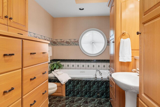 193 Honeybee Dr, Branson, MO 65615 - bathroom featuring a garden tub, toilet, marble look tiles, and vanity